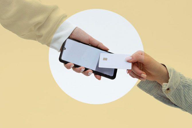 Unlock Hidden Card Revenue with BINs; A hand holds a smartphone, while another hand offers a credit card for contactless payment. The background is a soft beige, creating a modern, tech-savvy tone.