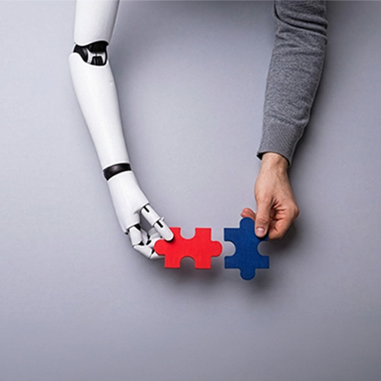 Robot and human hands connecting puzzle pieces